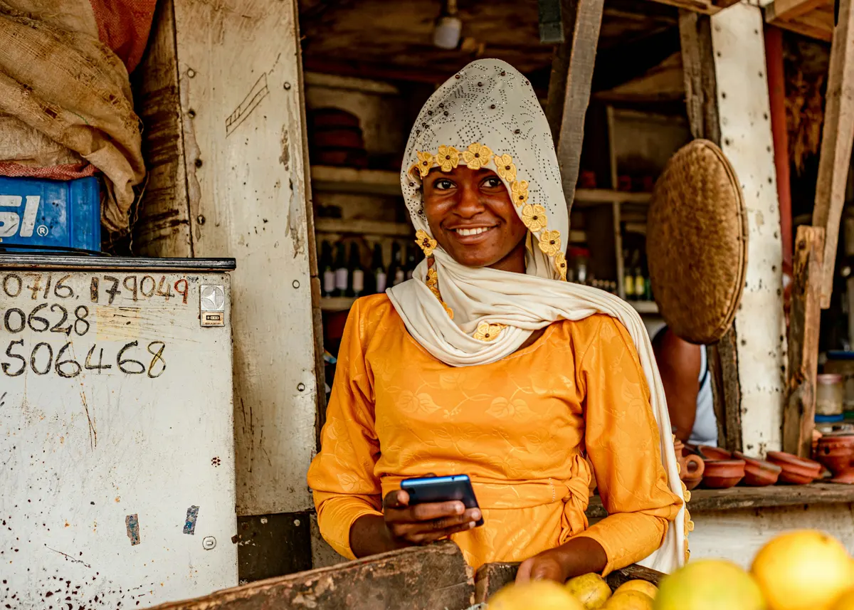 A stallholder smiling behind her counter