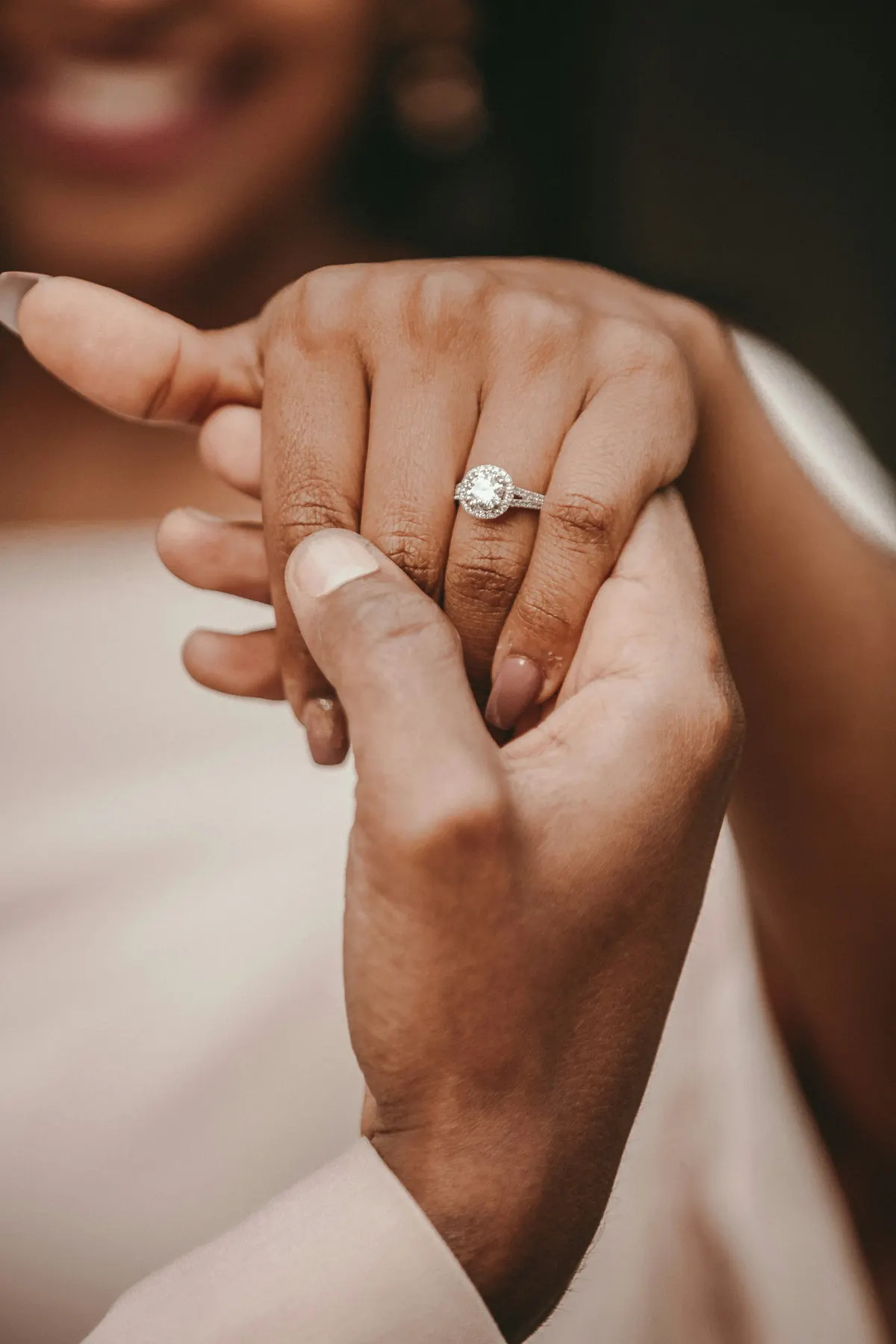 The groom holding the bride's ring hand