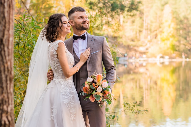 Bride and groom by a lake in autumn